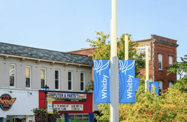 Downtown Whitby street banners representing the residential and commercial asphalt paving service area for Action Paving in Whitby, Ontario.
