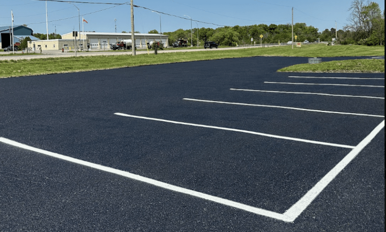 Freshly paved commercial asphalt parking lot with crisp white line painting completed by Action Paving in Ajax Ontario.