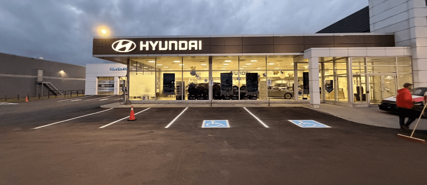 Commercial dealership parking lot with fresh asphalt paving and accessible parking stall line painting completed in Brampton ON by Action Paving.
